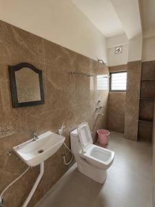 a bathroom with a toilet and a sink at KwaChen Stays in Panchanai