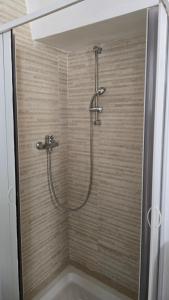 a shower with a shower head in a bathroom at Casa Alba in Bernalda +25 photos