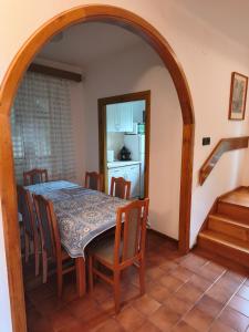 a kitchen and dining room with a table and chairs at Váralja Vendégház Tihany in Tihany