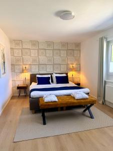 a bedroom with a large bed with blue pillows at FACT Apartments in Arnoldstein