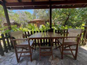 a wooden table and chairs on a patio at Kybele Nature Life in Edremit