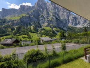 a view of a mountain from a house with a fence at Schlossli-Le Petit Chateau in Leukerbad