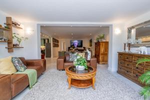 a living room with a couch and a table at 8 Sleeper, 4 Bedroom Home in Franschhoek in Franschhoek +36 photos