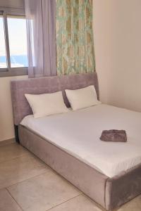 a bed sitting in a room with a window at Dream house in Eilat
