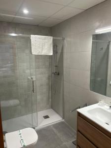a bathroom with a shower and a toilet and a sink at Hostal - Restaurante Playa Azul in Villaricos +67 photos