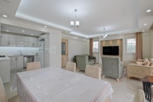 a large kitchen and living room with a table and chairs at villa hazar in Ortaca