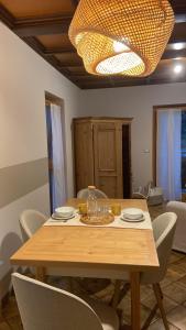a dining room table with chairs and a chandelier at Casette Margherita in Fiera di Primiero +28 photos