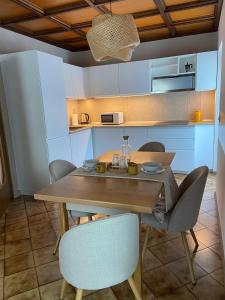 a dining room with a wooden table and chairs at Casette Margherita in Fiera di Primiero