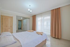 a bedroom with a large bed and a large window at villa hazar in Ortaca +52 photos