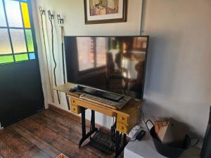 a living room with a large television on a table at Don Vito Casa de Huespedes in Cucullú
