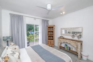 a bedroom with a bed and a fireplace at 8 Sleeper, 4 Bedroom Home in Franschhoek in Franschhoek