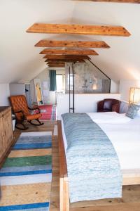 a bedroom with a large bed and a couch at Kellerstöckl am Neusetzberg in Straden