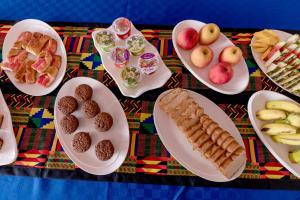 a table with plates of food on a table at Marera Eco Lodge in Karatu