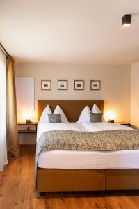 a bedroom with a large bed with two pillows at Kellerstöckl am Neusetzberg in Straden +8 photos