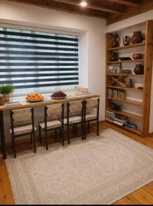 a kitchen with a table and chairs and a window at Sho Hostel in Khorugh