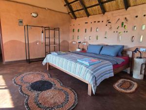a bedroom with a bed in a room at Marudzi Sunset Lodge in Umtali +8 photos