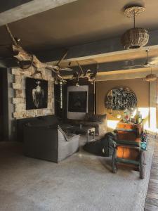 a living room with a couch and a tv at Hotel Makaabá Eco-Boutique in Bacalar