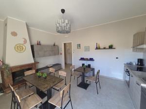 a kitchen and dining room with tables and chairs at B & B L'Altropianeta in Spoltore +28 photos