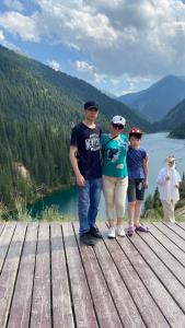 a group of people standing on top of a wooden pier at Guest house Aibek in Kurmenty +12 photos