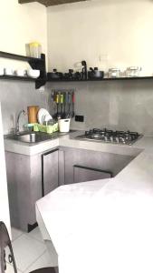 a kitchen with a sink and a stove top oven at Mejor relación Precio Comodidad in San Diego +4 photos