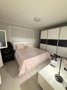 a bedroom with a bed and a table with a lamp at Villa Magnifica in Mostar