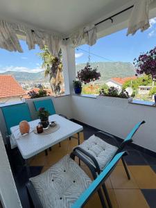 a table and chairs on a balcony with a view at Villa Magnifica in Mostar