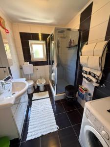a bathroom with a sink and a washing machine at Villa Magnifica in Mostar +7 photos