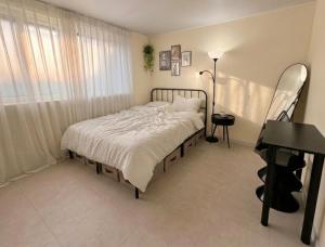 a bedroom with a bed and a desk and a piano at Elimhouse in Ansan