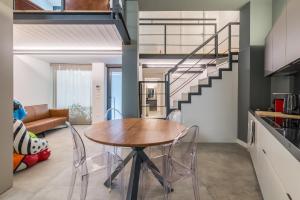 a kitchen and dining room with a table and a staircase at Effealatapartments - EdenLoft in Senigallia