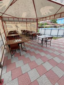 a group of tables and benches in a tent at Comfort Guest House in Borovoye