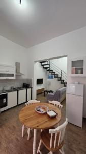a kitchen and dining room with a wooden table and chairs at Mari del sud in Bagheria
