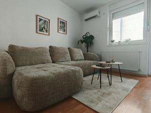 a living room with a couch and a table at Stella Verde in Vršac