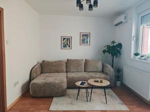 a living room with a couch and a table at Stella Verde in Vršac