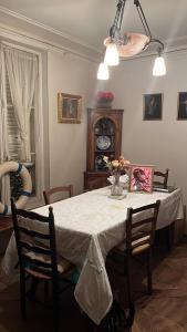 a dining room table with a vase of flowers on it at Chambre à Montmartre in Paris