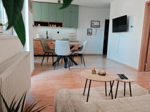 a living room with a table and chairs at Stella Verde in Vršac +11 photos