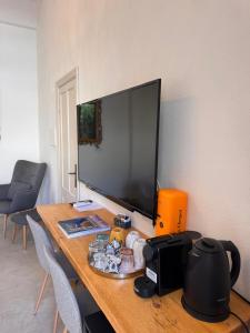 a desk with a large monitor on top of it at Depandance Eleonora in Oristano