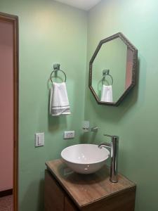 a bathroom with a white sink and a mirror at Apartamento Flor de Manila in Medellín