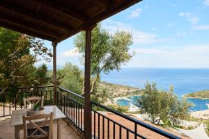 a balcony with a table and a view of the ocean at Vigla Villas in Volímai