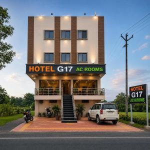 a hotel with a car parked in front of it at Hotel G17 and Restaurant in Dhāmnod