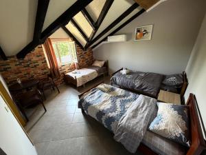 a living room with a bed and a couch at Camping Culaj in Koplik