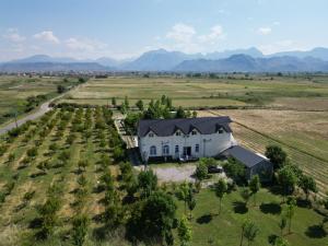 an aerial view of a white house in a field at Camping Culaj in Koplik