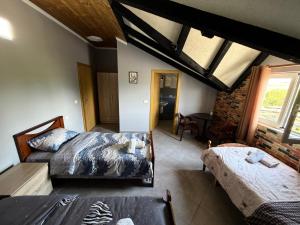 a bedroom with two beds and a table in it at Camping Culaj in Koplik