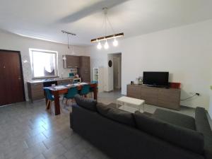 a living room with a couch and a table at La vedetta di Castrocucco in Tortora