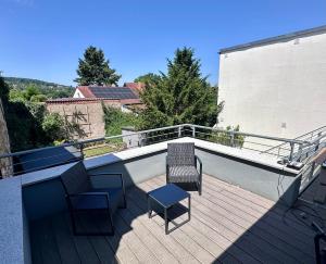a balcony with two chairs and two chairs on a roof at Comfort in Bamberg