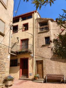 a building with a bench in front of it at Cal Folquer in Alentorn