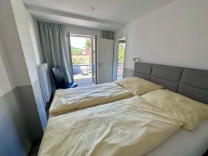 a bedroom with two beds and a balcony at Comfort in Bamberg