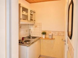 a small kitchen with a sink and a counter at Panoramahuis in Sukoró