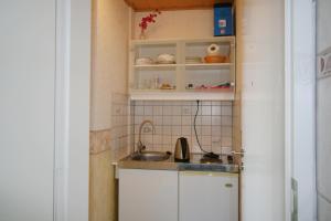 a small kitchen with a sink and a counter at Panoramahuis in Sukoró +2 photos