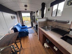 a kitchen and living room of an rv at The Carriage Lorry at Tilleys Glamping in Birchington