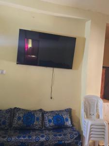 a room with a couch and a tv on the wall at Gîte Dayet Chiker in Taza +48 photos